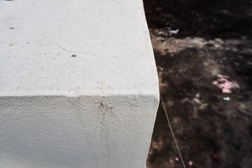 Close up of textured white concrete corner with rough surface details