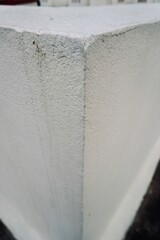 Top view of white painted concrete block showing cracks and marks