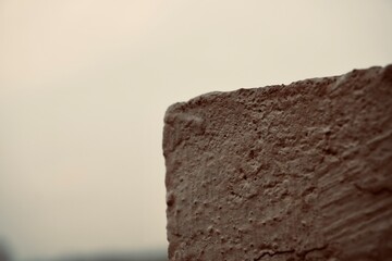 Abstract shot of concrete wall edge with dramatic lighting and earthy tones
