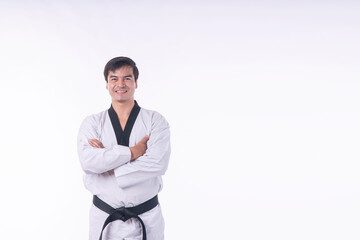 Handsome man wear white karate uniform black belt smiling and posing arms crossed standing copy...