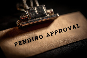 Pending Approval text on paper held by metal clip