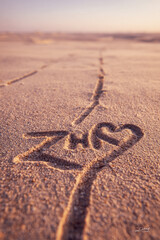 Z and H Initials Naturally Sketched into Smooth Beige Sand with Minimalist Romantic Texture – great for wedding keepsakes