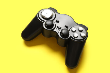 Modern game pad on yellow background