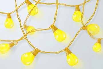 Yellow string lights, bulb style, on a light background