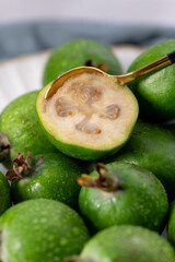 Macro of a half-cut feijoa fruit with a spoon