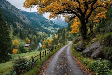 Obraz premium A scenic autumn landscape featuring a winding road surrounded by vibrant yellow and orange trees. Mountains and a small house are visible in the background.