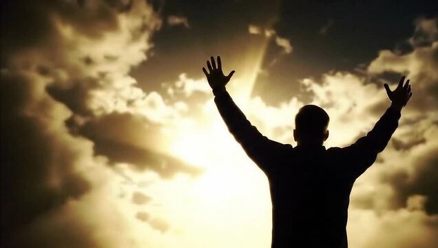 A silhouette of a person with arms raised to the sky, bathed in dramatic, golden sunlight breaking through dramatic, cloudy skies - believer's power of religion Jesus Savior