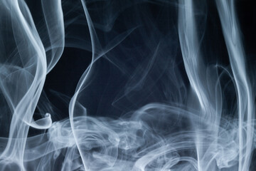Wisps of smoke swirling in a dark background create a mystical atmosphere