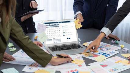 Analyst team use sticky note for creative and analytic brainstorm for business idea with BI data dashboard on laptop screen. Analysis financial data visualization tech for marketing strategy. Prodigy