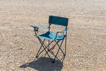 A Foldable camping chair on the brown background