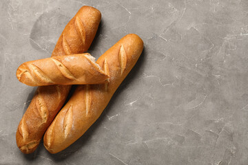 Fresh baguettes on grey background