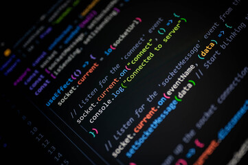 Close-up of colorful JavaScript code on computer screen, showing socket connection and server communication for modern web development, software programming, and digital technology concept.