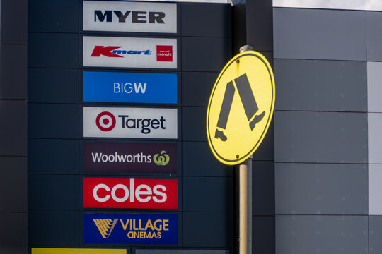 Retail signage display at Pacific Werribee shopping centre in Australia, featuring logos of major brands including Myer, Kmart, BIG W, Target, Woolworths, Coles, and Village Cinemas. 
