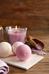 Composition with tray and bath bombs on brown wooden background, closeup