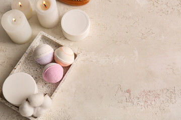 Composition with bath bombs and cosmetic products on beige grunge background