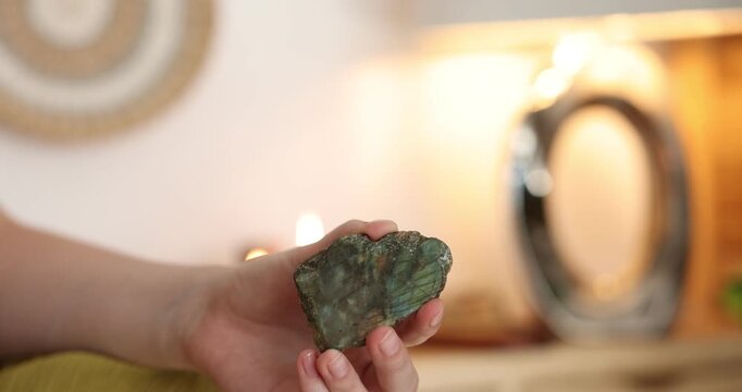 Woman with beautiful labradorite gemstone indoors, closeup