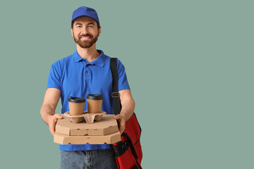 Male courier with pizza boxes and coffee cups on green background