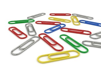 A collection of colorful and metallic paper clips scattered on a bright white background casting soft shadows