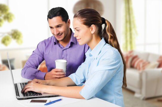 Young happy couple having fun using laptop - Powered by Adobe