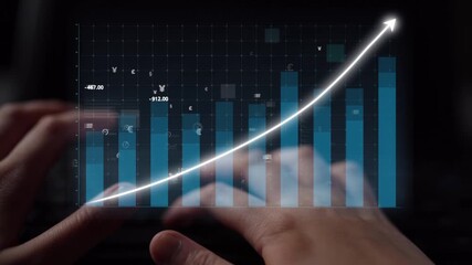 Close-up of hands typing on a keyboard, paired with a digital graph showing upward growth trends, representing the dynamic nature of the financial market and economy. Copula - Powered by Adobe