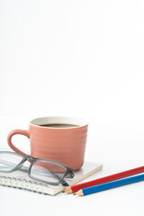 Enjoy a productive morning with a coffee break, glasses, and colorful pencils on a clean notepad, perfect for students, creatives, and professionals