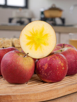 Fresh Yunnan Daliangshan Apples with Star Pattern Cross-Section on Kitchen Cutting Board