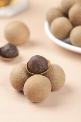 Dried Longan Fruit from Yunnan China with Brown Pulp on White Background