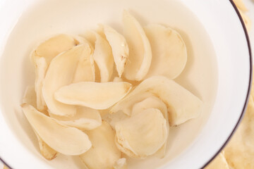 White Chinese Herbal Medicine Tonic Ingredients Soaking in Water Closeup Traditional Natural Remedy Preparation