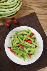 Fresh Kidney Bean Stir-Fry with Red Peppers on White Plate - Healthy Chinese Vegetable Dish