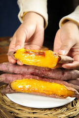 Roasted Sweet Potato with Honey Glaze - Traditional Japanese Yakiimo Snack in Hands