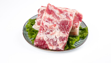 Raw Pork Ribs on Plate with Lettuce Garnish for Chinese BBQ Cooking