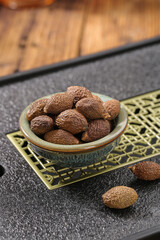 Dried Shiitake Mushrooms in Ceramic Bowl on Dark Stone Surface