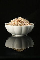 Tricolor Quinoa in White Bowl on Black Background - Healthy Superfood Grain Meal
