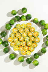 Fresh Hainanese Kumquats with Fragrant Citrus Halves in Deep-Bottomed Bowl - Asian Tropical Fruit Display