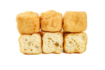 Deep-fried tofu cubes showing golden crispy exterior and soft airy interior texture on white background