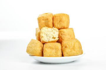 Deep Fried Golden Tofu Puffs on White Plate - Delicious Asian Cuisine Ingredient with Crispy Hollow Texture