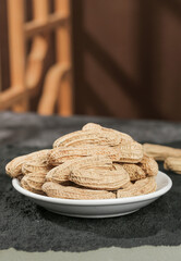 Dried Black Peanuts from Yunnan Province on White Plate - Selenium-Enriched Nuts with Detailed Shell Texture