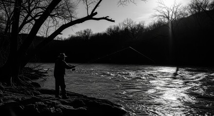 Silhouetted angler fly fishing on a sunlit river, casting line amidst winter trees.