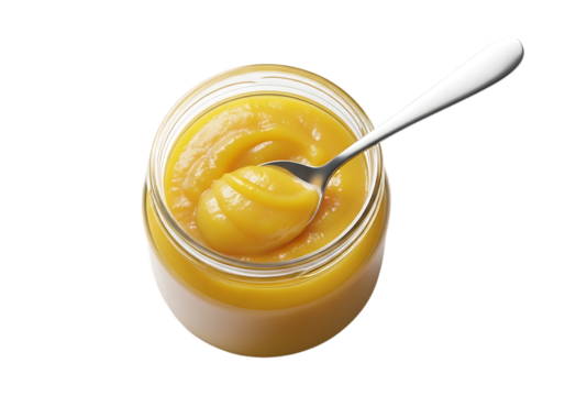 A glass jar filled with golden ghee clarified butter and a spoon inside isolated on transparent background