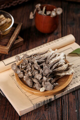 Dried Morel Mushrooms Traditional Medicine Ingredients with Deer Antler and Clay Pot on Wooden Table