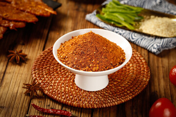 Guizhou Spicy Hot Pot Sauce Base Powder with Chili Peppers and Asian Spices on Wooden Table