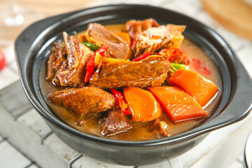 Countryside Goose Casserole with Braised Potatoes and Vegetables in Traditional Ceramic Pot