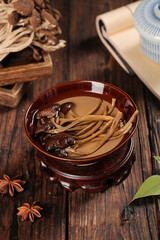 Traditional Asian Mushroom Soup with Shiitake and Enoki in Ceramic Bowl on Wooden Table