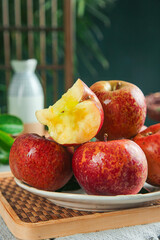 Fresh Daliangshan Apples on Bamboo Tray - Red Apple Slice Shows Golden Interior in Natural Kitchen Setting