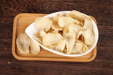Dried Lily Bulb Petals Chinese Herbs Traditional Medicine Tonic Ingredients Closeup on Wood