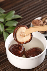 Fresh Shiitake Mushrooms with Chopsticks Over Hot Soup Bowl - Asian Cooking Ingredients
