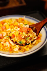 Special Golden Yangzhou Fried Rice with Egg and Vegetables on Wooden Spoon - Traditional Chinese Food