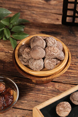 Dried Shiitake Mushrooms in Wooden Bowl - Fresh Asian Cooking Ingredients on Rustic Wood Table