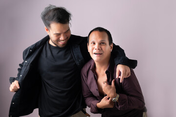 Smiling gay men looking at camera