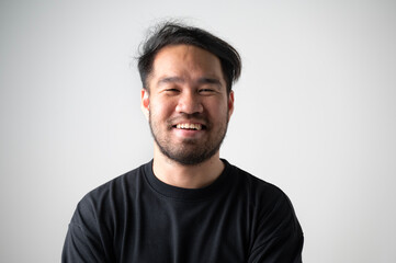 Portrait of handsome laughing bearded man in a black shirt